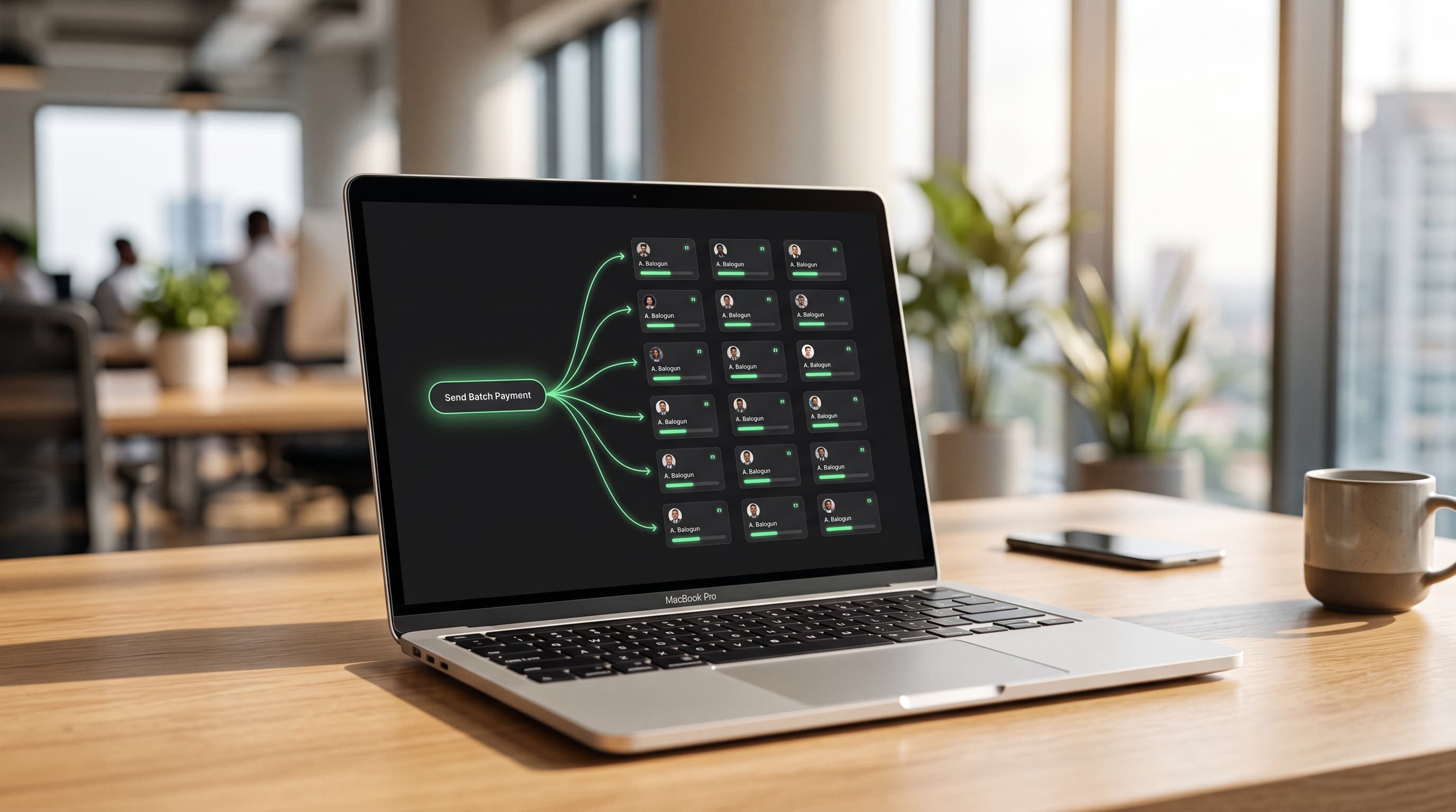 A laptop in a modern African office shows a fintech dashboard with payment tiles fanning out from a single batch payment action